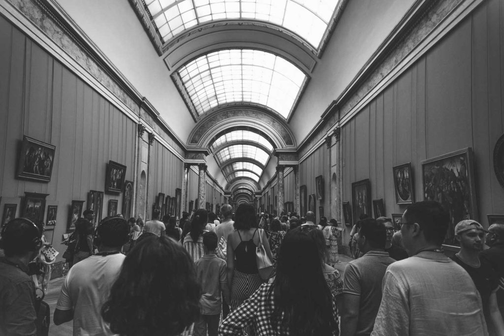The packed Grand Gallery in the famous Louvre museum in Paris shows why responsible tourism is important